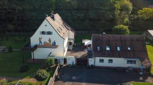 an aerial view of a house with two people on the roof at Ferienwohnung an der Mainschleuße in Harrbach