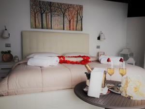 a bedroom with a bed and a table with wine glasses at Villa Treglia in Formia