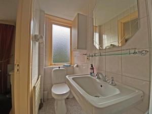 a bathroom with a sink and a toilet and a mirror at Villa Prinsenhof # Tweeëntwintig in Bergen