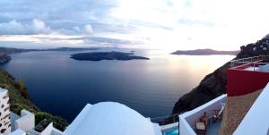 a view of the ocean from the side of a building at Hara's houses in Imerovigli