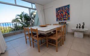 a dining room with a table and chairs and a large window at 17 Kyalanga Umhlanga Rocks in Durban