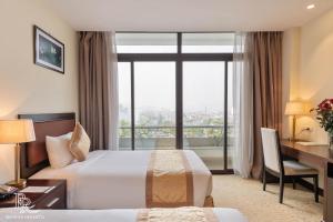 Ένα ή περισσότερα κρεβάτια σε δωμάτιο στο Red River View Hotel