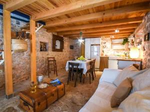a living room with a white couch and a table at 450 year-old house with a garden in Stari Grad