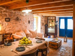 a dining room with a table with fruit on it at 450 year-old house with a garden in Stari Grad