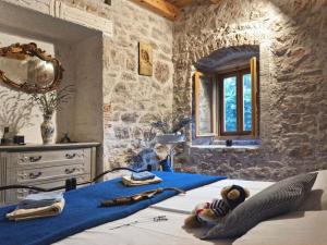 a bedroom with a blue blanket on a bed at 450 year-old house with a garden in Stari Grad