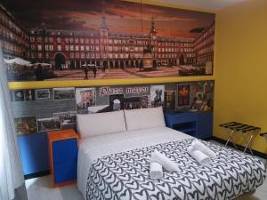 a bedroom with a king sized bed with a large painting at Hostal Jo Inn Madrid in Madrid