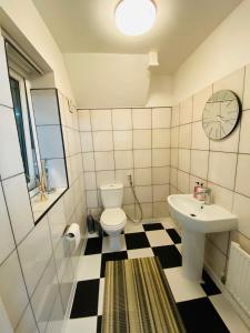 a bathroom with a white toilet and a sink at Birmingham Guesthouse in Birmingham