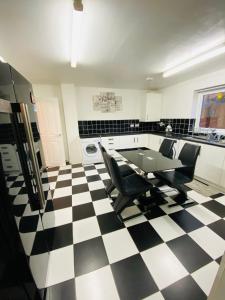 a kitchen with a black and white checkered floor at Birmingham Guesthouse in Birmingham