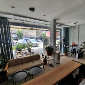a living room with a couch and tables and chairs at Circle One in Palembang