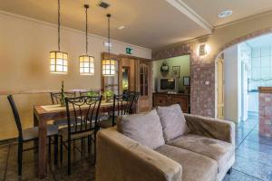 a living room with a couch and a dining room table at Casa Rural Ca Lluis in La Vall de Laguar