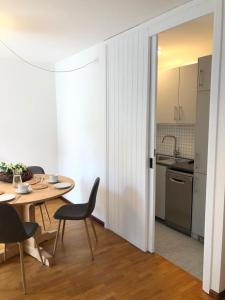 a kitchen and dining room with a table and chairs at I Cirmoli in Bormio