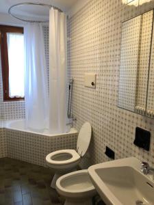 a bathroom with a toilet and a sink at I Cirmoli in Bormio