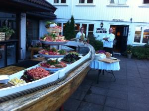 a display of food on a table in front of a building at Risør Hotel in Risør
