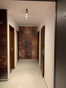 an empty hallway with doors and a tile floor at ApartsW241 in Jelenia Góra