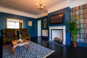a living room with a fireplace and a tv at No.89 Stylish Ground Floor Apartment in Paignton