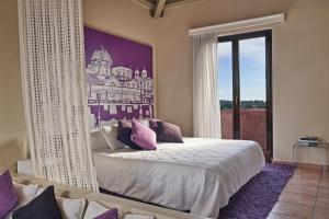 a bedroom with a bed and a large window at Angelina Boutique Escape in Perdika