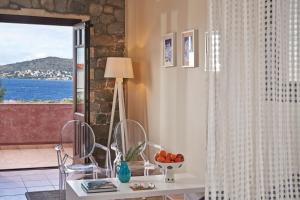a living room with a table and a window at Angelina Boutique Escape in Perdika