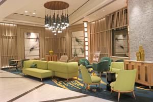 a lobby with couches and chairs and a chandelier at Holiday Inn Chandigarh Zirakpur, an IHG Hotel in Chandīgarh