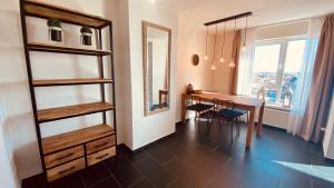 a dining room with a table and a mirror at At Juliette in Zandvoort