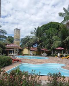 a pool at a resort with palm trees at Hotel Jardim Tropical in Barcarena +28 photos