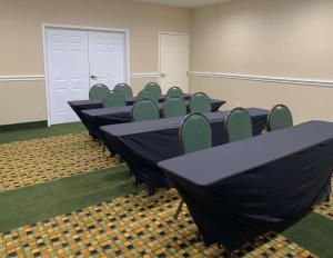 una fila de mesas y sillas en una habitación en MainStay Suites Addison - Dallas, en Addison
