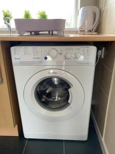 a washing machine in a kitchen with a counter at Stay Seaton Delaval in Seaton Delaval