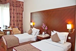 Postel nebo postele na pokoji v ubytování Regent Palace Hotel