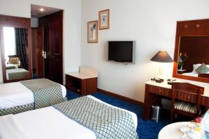 Postel nebo postele na pokoji v ubytování Regent Palace Hotel