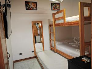 a room with two bunk beds and a mirror at Cabaña Kosta Azul Capurganá in Capurganá