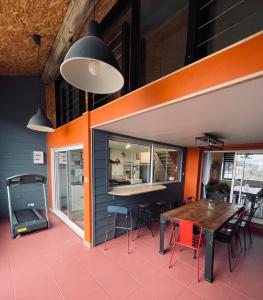 a dining room with a wooden table and chairs at La BOUGERIE de Chaligny à 15 min de Nancy in Chaligny