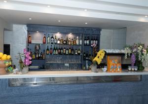 a bar with a lot of bottles of alcohol at Casthotels Baia delle Sirene in Forio d'Ischia