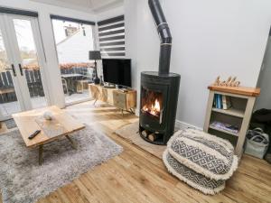 a living room with a fireplace and a tv at 5 Lake House in Lancaster