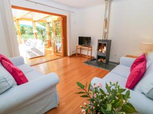 a living room with two white couches and a fireplace at Lynhays in Launceston