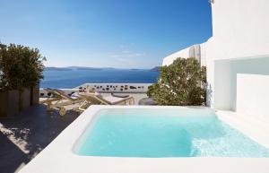 a swimming pool with a view of the ocean at Atrina Canava 1894 in Oia