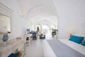 a large room with a large bed and a large window at Atrina Canava 1894 in Oia
