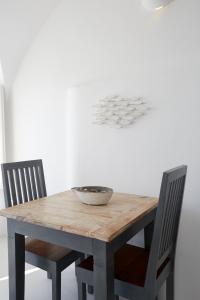 a dining room table with a bowl of soup on it at Atrina Canava 1894 in Oia