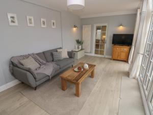 a living room with a couch and a coffee table at Castle at The Hideaway in Tenby