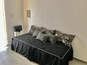 a bedroom with a bed with black sheets and pillows at BRISAS DEL VALLE San Rafael in Valle Grande +46 photos