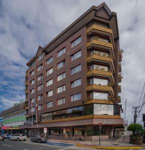 a tall building on the corner of a street at Hotel Don Luis Puerto Montt in Puerto Montt