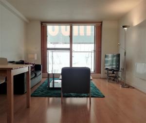 a living room with a desk and a chair in front of a window at Still Life Old Street Executive in London