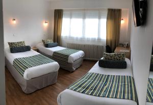 מיטה או מיטות בחדר ב-Cit'Hotel Atlantis