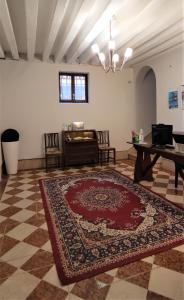 a large room with a rug and a piano at Porta Orientalis Venice in Venice