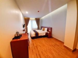 Postel nebo postele na pokoji v ubytování Rinny Hotel