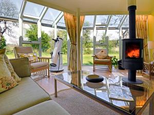 a living room with a couch and a fireplace at Black Burn Lodge B & B in Newcastleton