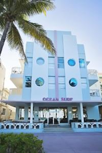 a large blue and white building with palm trees at Broadmore Miami Beach in Miami Beach
