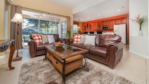 a living room with a couch and a table at Luxury Contemporary Style Villa on Windsor Hills Resort, Orlando Villa 5006 in Orlando