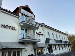 a hotel with two balconies on a building at Hotel am Rosenbad in Fulda