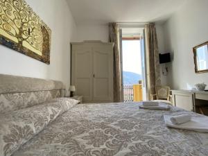 a bedroom with a bed and a window with a view at Villa Margherita in Levanto
