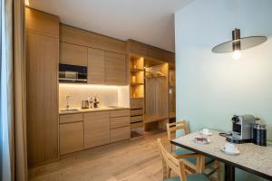 a kitchen with wooden cabinets and a dining table at OneBavariaHomes in Munich