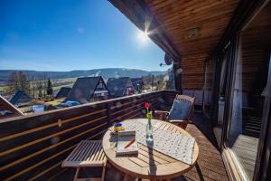 a wooden table on the balcony of a house at Rhön Häuschen in Bischofsheim an der Rhön